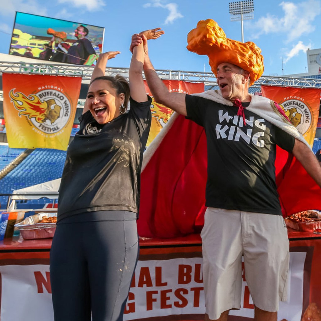 Photo of a man and women celebrating at the chicken wing festival