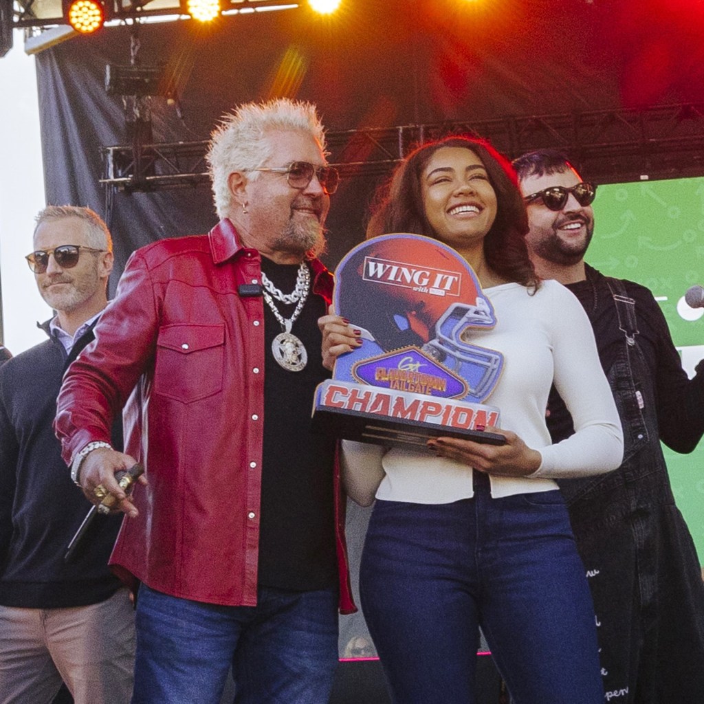 Photograph of Guy Fieri standing with "Wing It with Bota" recipe winner Natalie Harwood