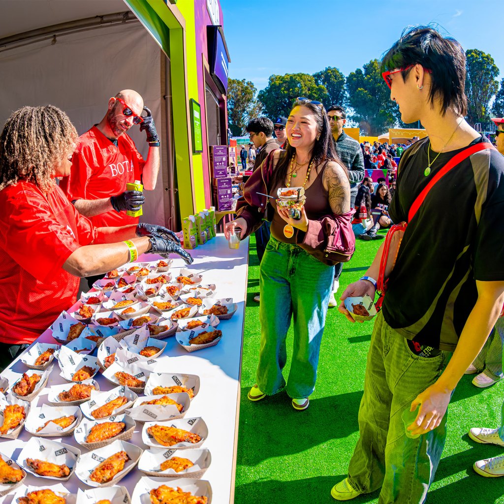 People sampling chicken wings at the Bota Box booth